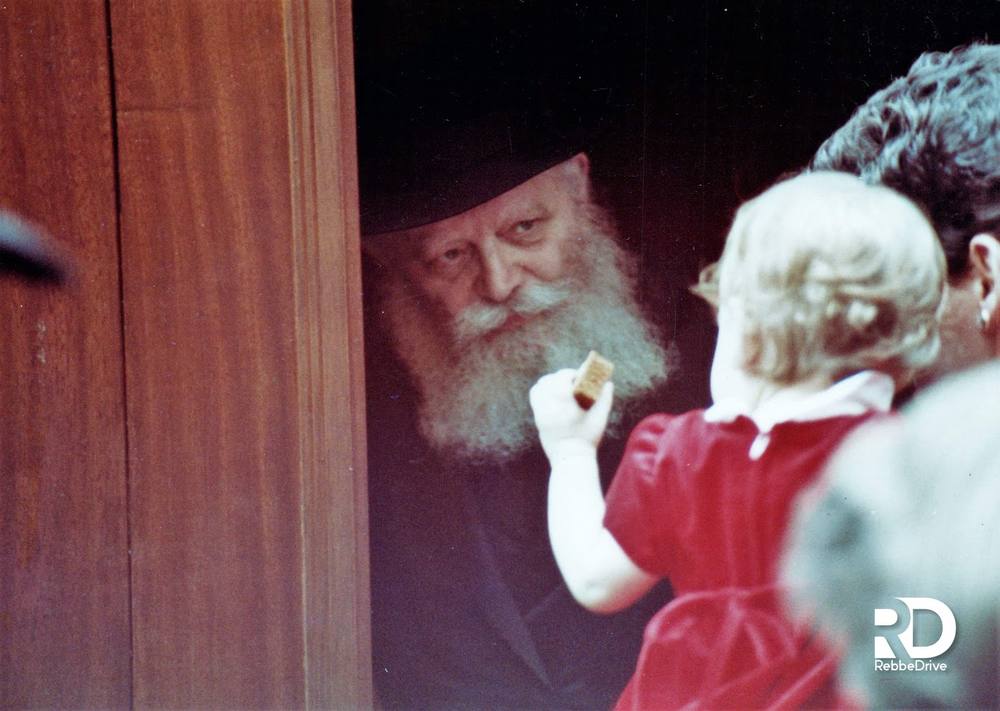 Handing out lekach to a little girl